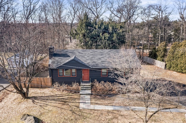 view of front of home with fence and a chimney