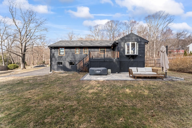 back of property featuring stairway, an outdoor hangout area, a lawn, and a patio