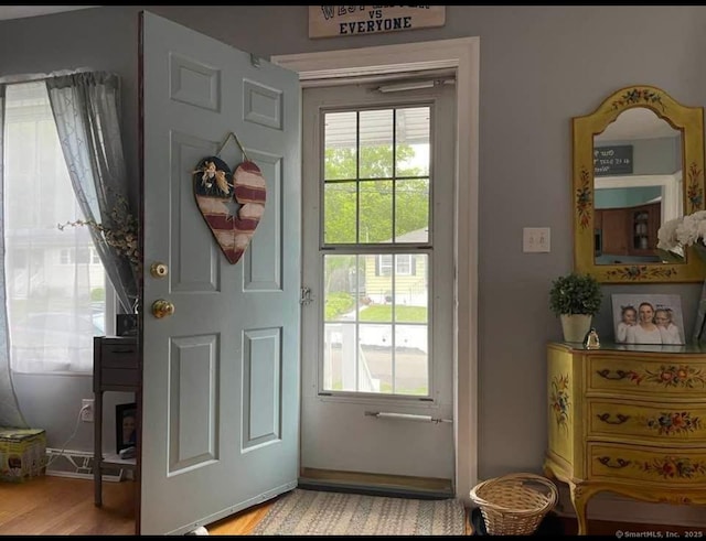 doorway to outside with light wood-style flooring