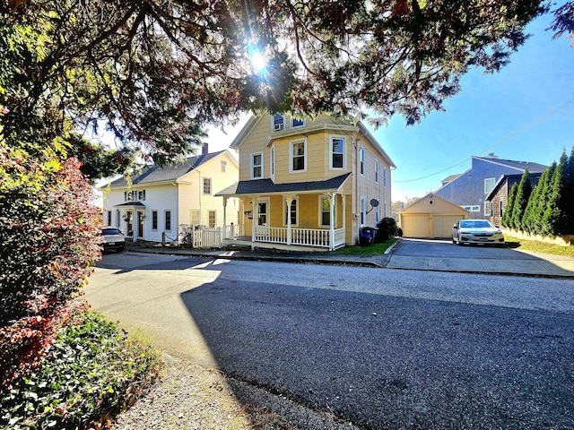 view of front of property featuring an outbuilding, a garage, and covered porch