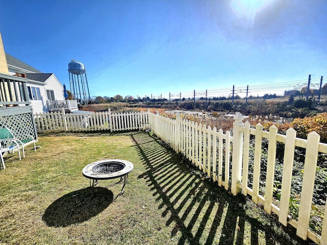 view of yard featuring a fire pit and fence