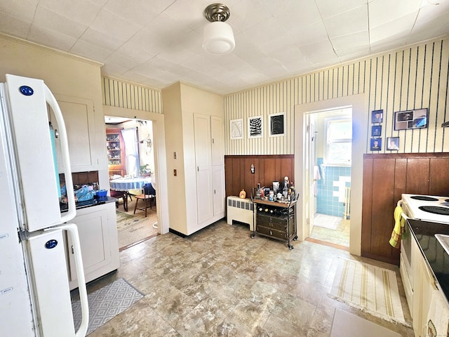 kitchen featuring white appliances and wallpapered walls