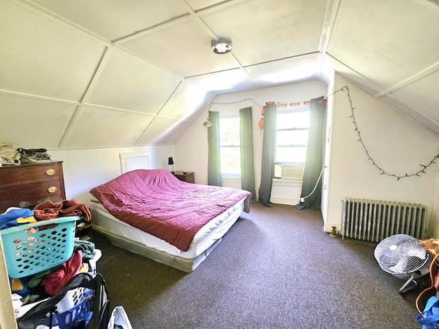 carpeted bedroom with radiator heating unit and vaulted ceiling