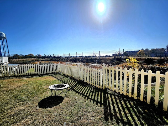 view of yard with a fire pit and fence