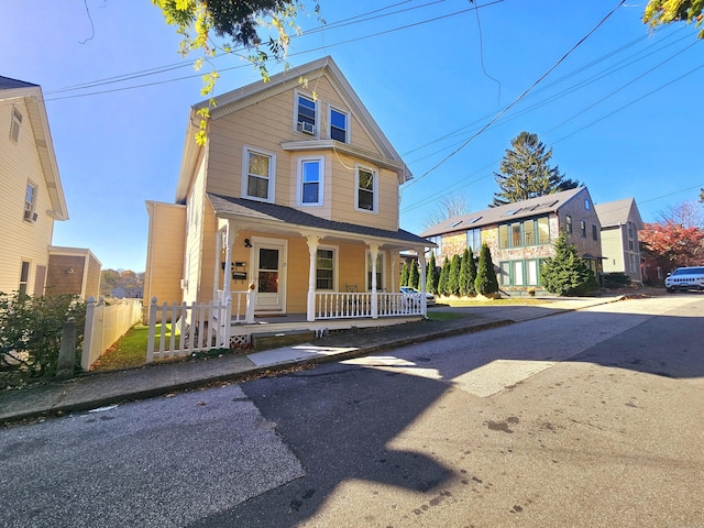 view of front of house featuring a porch and fence