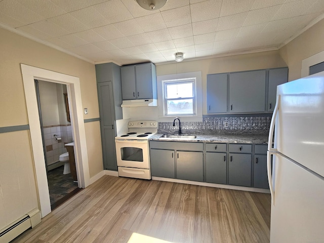 kitchen featuring a sink, a baseboard radiator, white appliances, and gray cabinetry