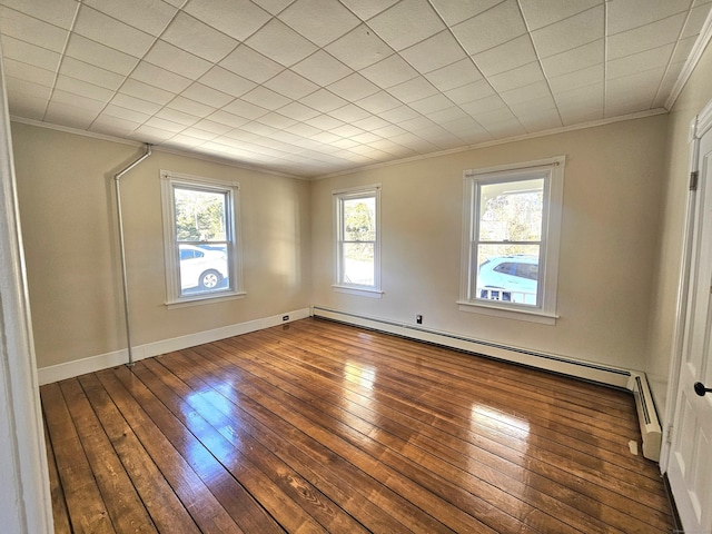 unfurnished room with crown molding, hardwood / wood-style flooring, baseboards, and a baseboard radiator