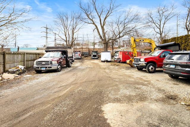 view of parking featuring fence