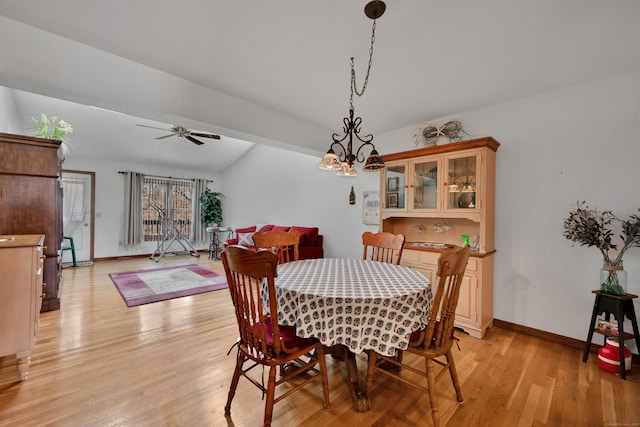 dining area featuring baseboards, light wood-type flooring, and ceiling fan