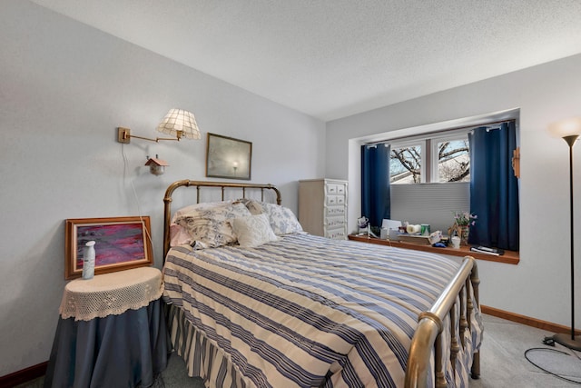 carpeted bedroom featuring a textured ceiling and baseboards