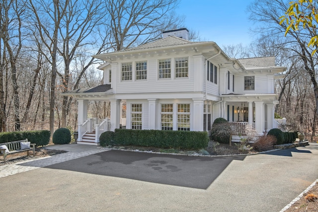 view of front of property featuring covered porch and a chimney