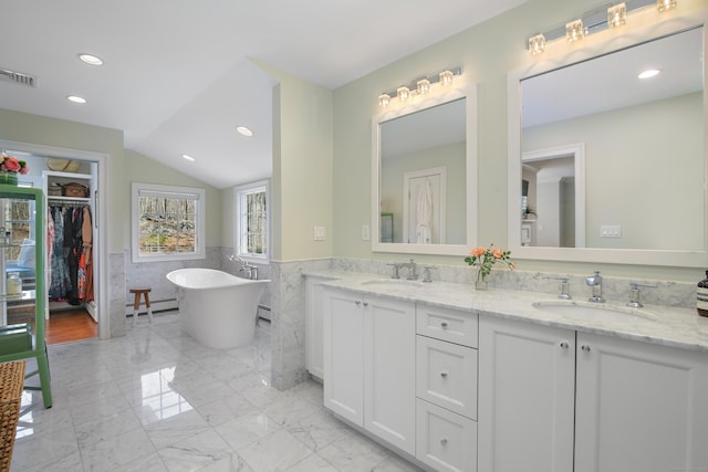 full bathroom featuring a wainscoted wall, marble finish floor, a baseboard radiator, and a sink