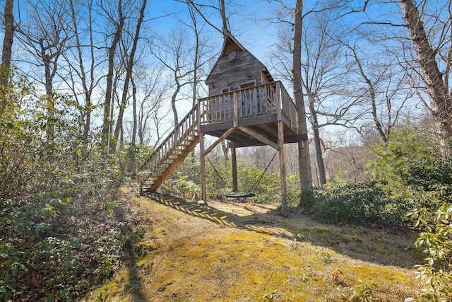 view of yard featuring a deck and stairs