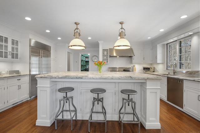 kitchen featuring white cabinetry, glass insert cabinets, a kitchen island, and stainless steel appliances