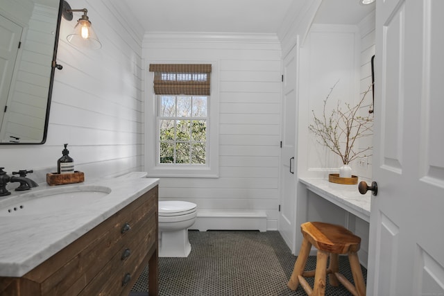 bathroom featuring tile patterned floors, toilet, vanity, and crown molding