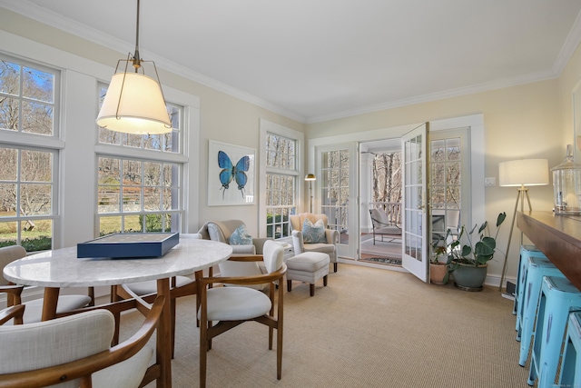 dining room featuring light carpet and ornamental molding