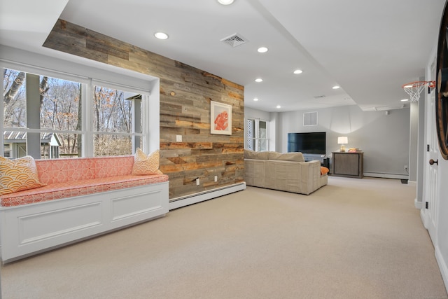 living area featuring wooden walls, recessed lighting, visible vents, and baseboard heating