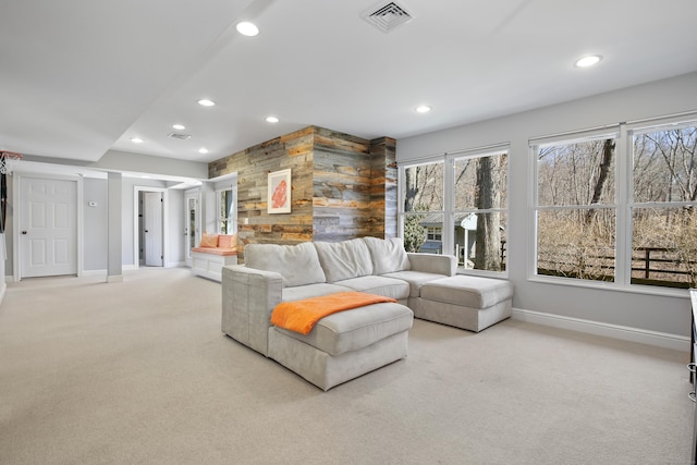 living room featuring recessed lighting, visible vents, light colored carpet, and a wealth of natural light