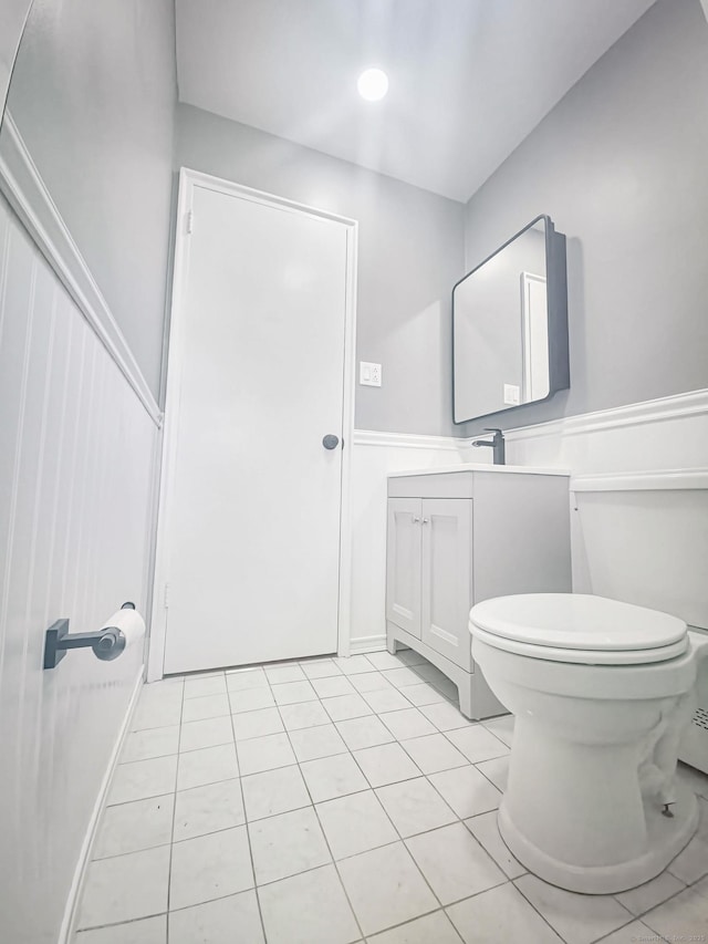 bathroom with tile patterned flooring, toilet, and vanity