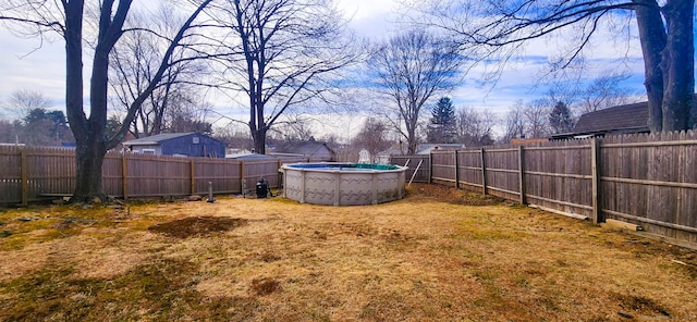 view of yard with a fenced in pool and a fenced backyard