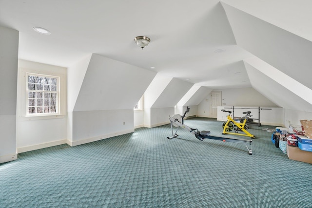 additional living space featuring baseboards, carpet floors, and vaulted ceiling