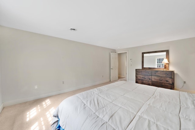 bedroom with visible vents, baseboards, and carpet