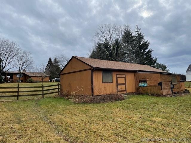 view of outbuilding with an outdoor structure and fence