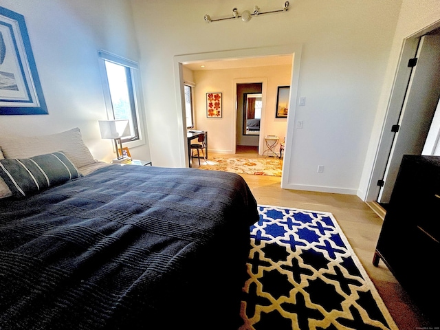 bedroom with baseboards and light wood-style flooring