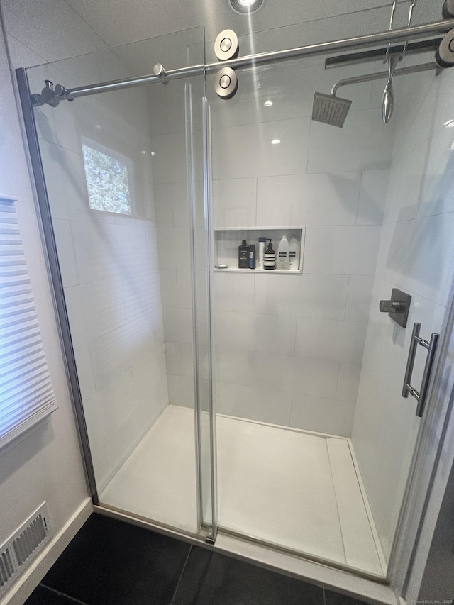 bathroom with visible vents and a stall shower