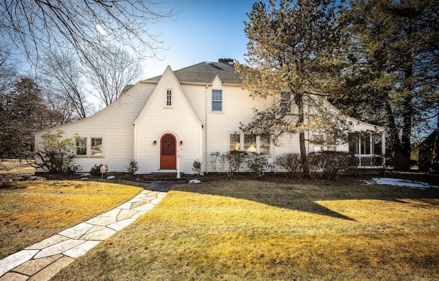 tudor-style house with a front yard