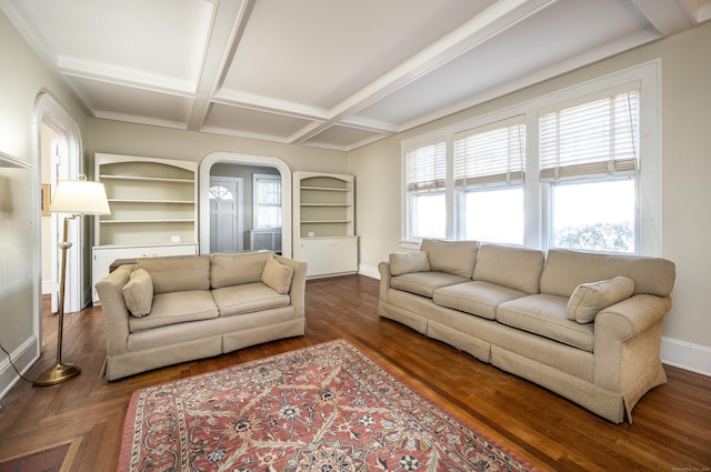 living area featuring wood finished floors, baseboards, coffered ceiling, beam ceiling, and arched walkways