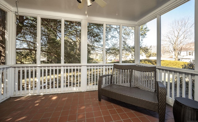 unfurnished sunroom featuring ceiling fan