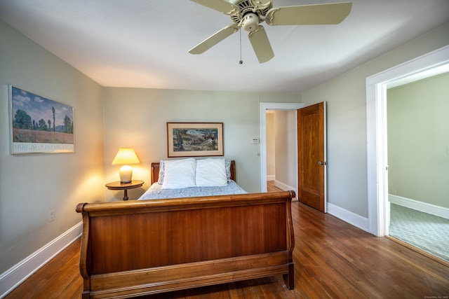 bedroom featuring ceiling fan, baseboards, and dark wood-style floors