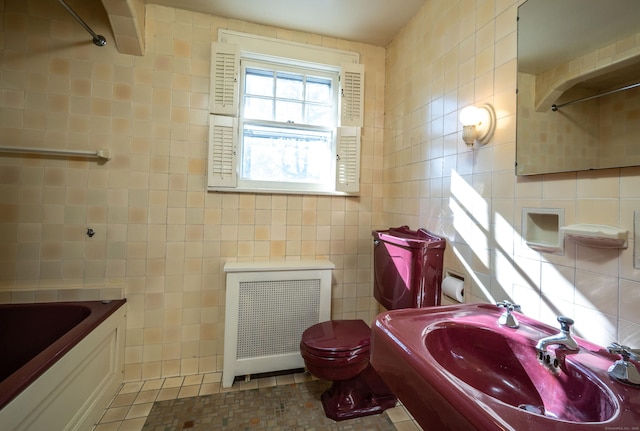 full bathroom featuring walk in shower, tile walls, radiator heating unit, and a sink