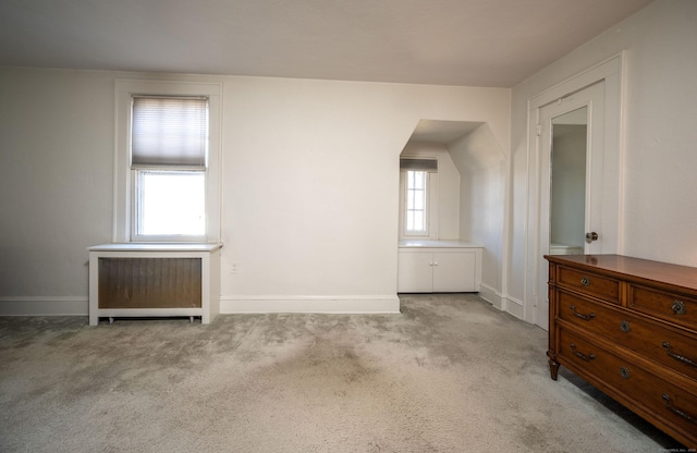 empty room featuring baseboards and carpet