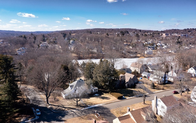 birds eye view of property featuring a view of trees