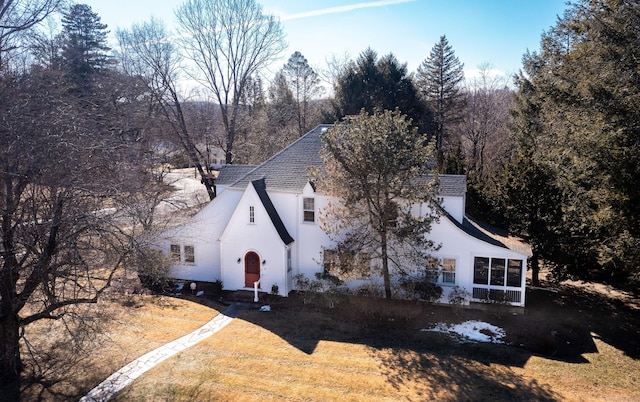 view of property exterior featuring a sunroom