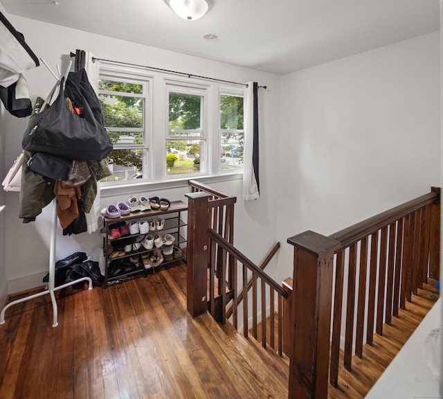 stairs featuring baseboards and hardwood / wood-style flooring