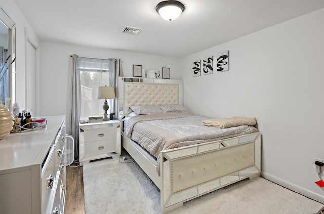 bedroom featuring visible vents and baseboards