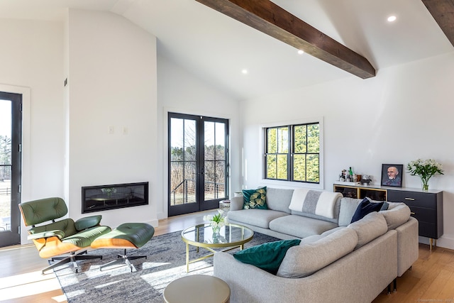 living room featuring high vaulted ceiling, beamed ceiling, light wood finished floors, recessed lighting, and french doors