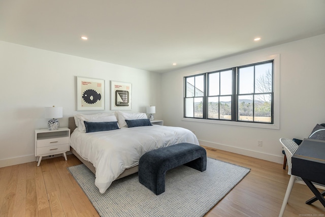 bedroom featuring baseboards, light wood finished floors, and recessed lighting