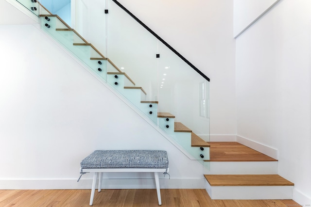 stairs with baseboards and wood finished floors