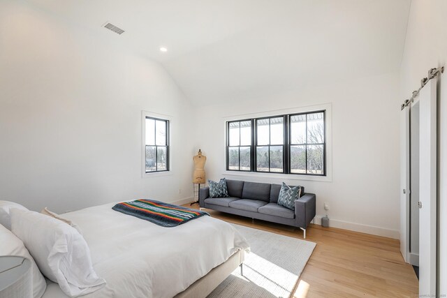 bedroom with vaulted ceiling, recessed lighting, baseboards, visible vents, and light wood-style flooring