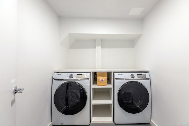 laundry room with laundry area, baseboards, and separate washer and dryer