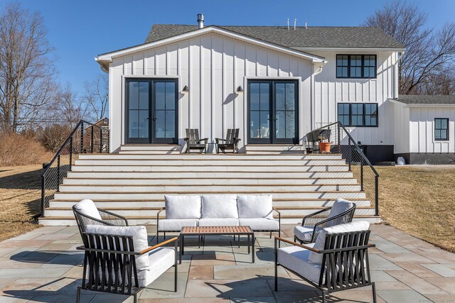 back of property with a patio, board and batten siding, and french doors