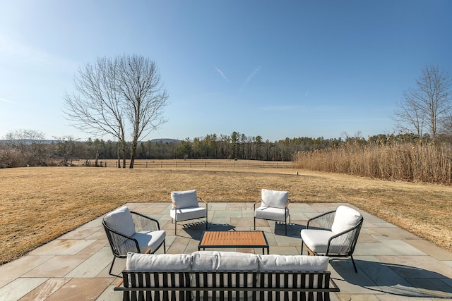 view of patio with outdoor lounge area and a rural view