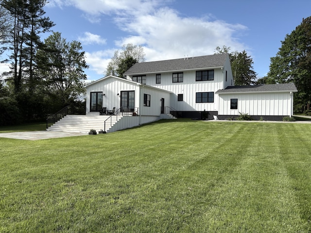 323 Wells Hill Rd, Salisbury, CT 06039 - rear view of house featuring board and batten siding, stairs, a lawn, and roof with shingles