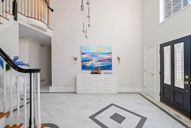 215 Paddock Hill Ln, Fairfield, CT 06824 - foyer entrance with light marble finish floors, a towering ceiling, stairway, and baseboards