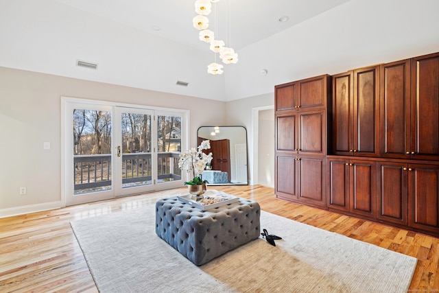 sitting room featuring visible vents, baseboards, vaulted ceiling, light wood-style flooring, and an inviting chandelier