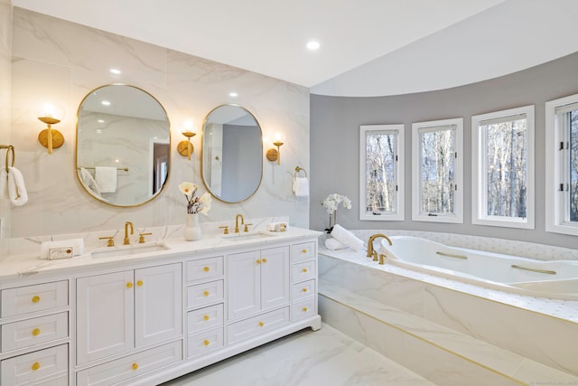 215 Paddock Hill Ln, Fairfield, CT 06824 - bathroom with marble tiled flooring, a garden tub, double vanity, and lofted ceiling